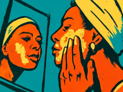 A person with a towel wrapped around their head applies white lather to one cheek in front of a small propped mirror, their reflection visible in it, rendered as a flat orange, teal and yellow illustration.