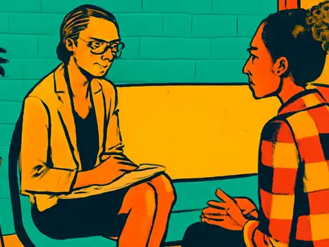 Two people sit facing each other in chairs, one holding a notepad on their lap and looking down at it, the other gesturing with one hand, a plant on a stool beside them, rendered as a flat teal, orange and yellow illustration.