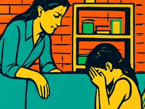 An adult leaning over the back of a sofa towards a child sitting with their face in their hands, a bookshelf and brick wall behind them, rendered as a flat teal, orange and yellow illustration.